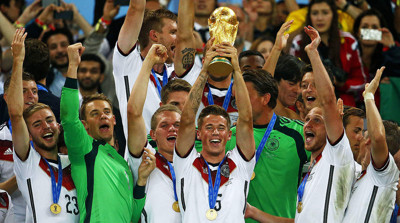 A moment of immortality: Erik Durm (centre) hoists the World Cup trophy © Bongarts/GettyImages