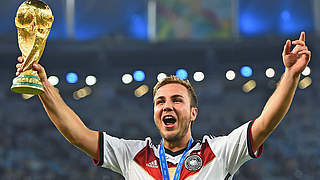 Götze celebrates with the Jules Rimet trophy after firing Germany to the World Cup © 2014 Getty Images