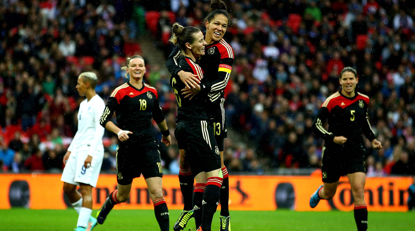 Laudehr and Sasic celebrate in Wembley Stadium © 2014 Getty Images