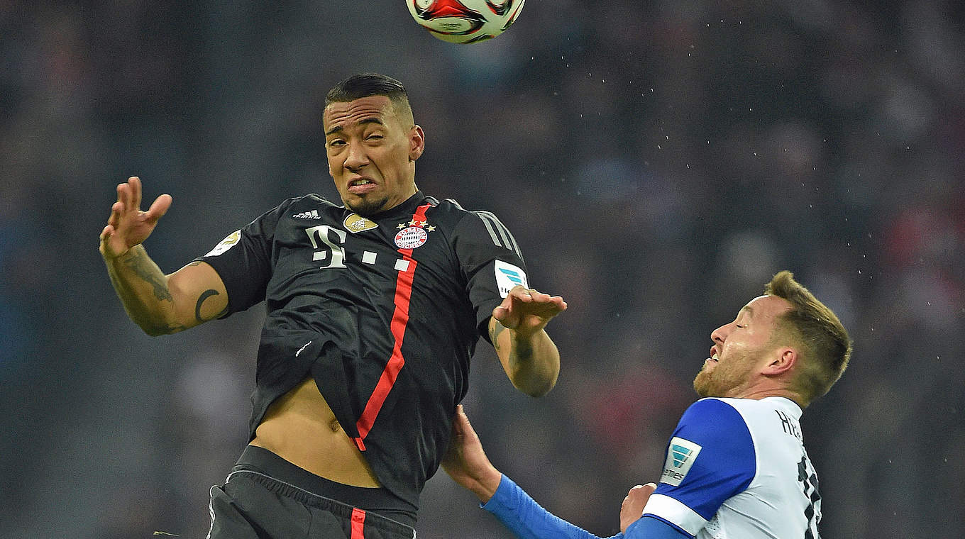 Bayern's Boateng going up for a header against Hertha BSC's Schieber. © 2014 Getty Images