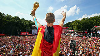 'Lap of honour': Bastian Schweinsteiger with the trophy at the fan mile. © 2014 Getty Images
