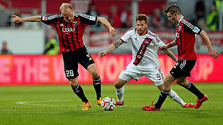 Ingolstadt players Levels and Groß surround Nürnberg's Burgstaller © 2015 Getty Images