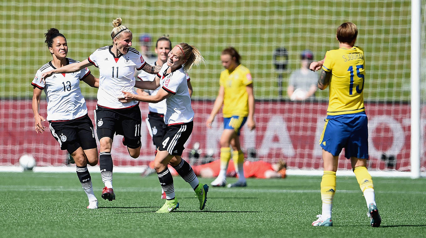Anja Mittag (centre) celebrates her opening goal © 2015 Getty Images
