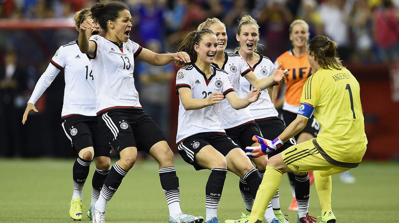 Angerer mobbed by teammates after her heroics © 2015 Getty Images