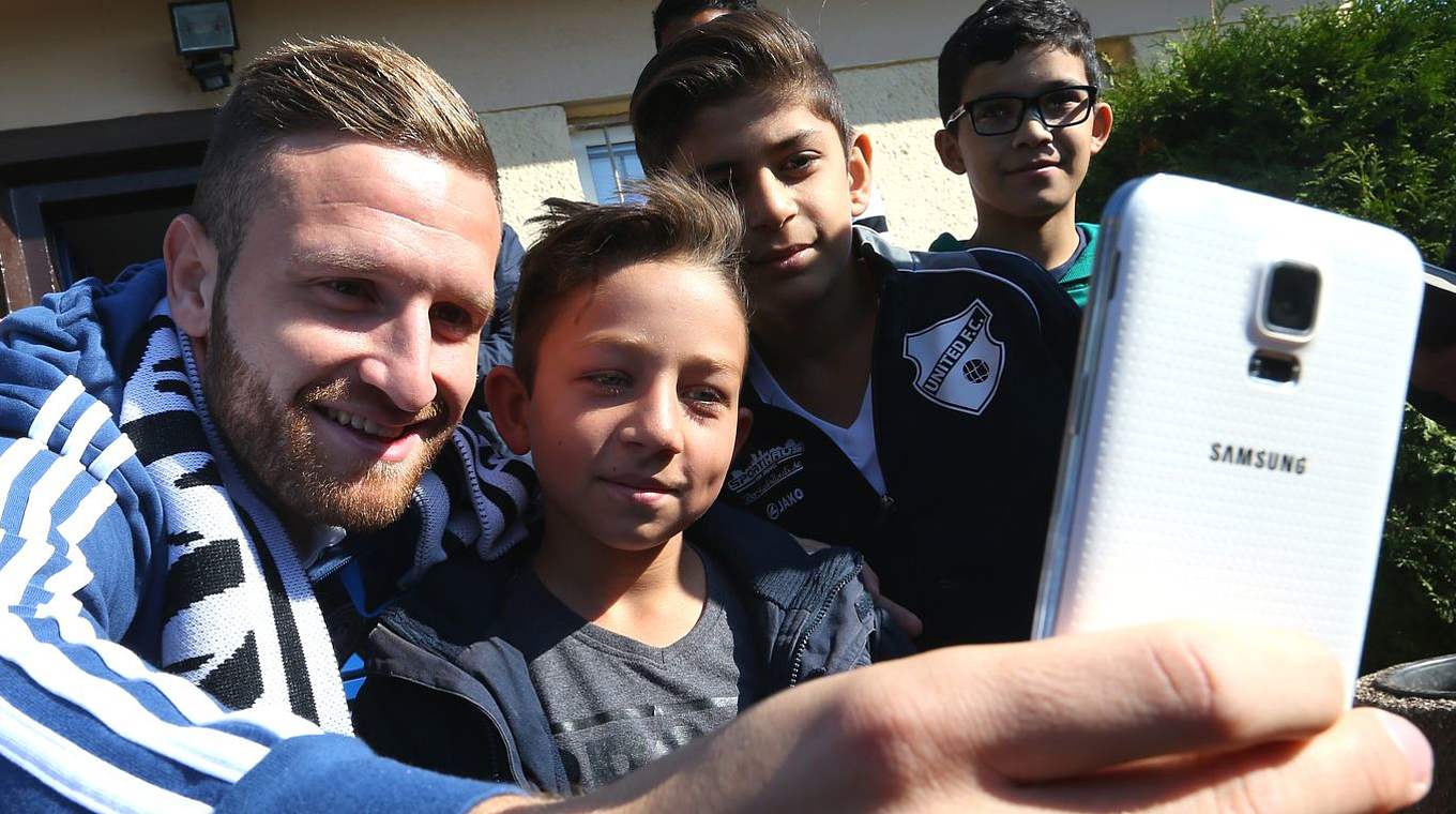 Selfie mit dem Weltmeister: Shkodran Mustafi hat Spaß mit den jungen Fans © 2015 Getty Images