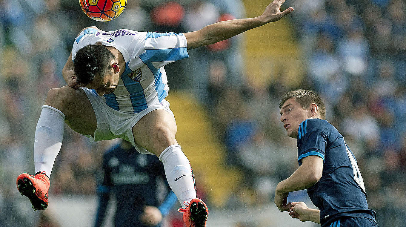 Toni Kroos watchs on as Charles takes the ball in an unorthodox fashion © ©AFP/Getty Images