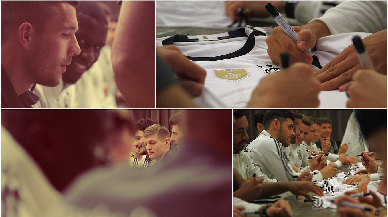 The players sit down to sign autographs on kits and other types of merchandise © DFB