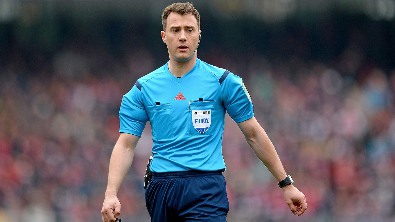  Felix Zwayer is shown wearing a blue FIFA referee uniform, ready to officiate a soccer match.