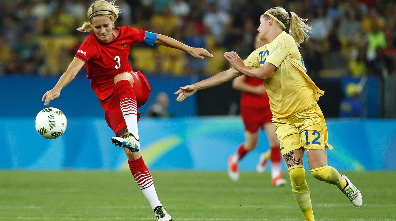 Dominant defence: Captain Saskia Bartusiak clears the ball out of Olivia Schough's path  © AFP/Getty Images