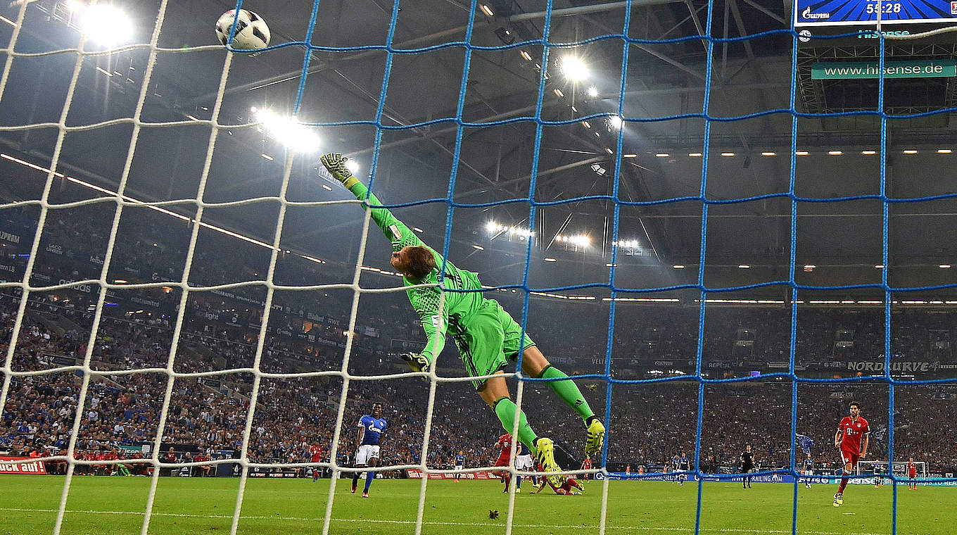 A stunning save on his old stomping ground: Neuer tips Huntelaar's shot onto the bar © AFP/Getty Images