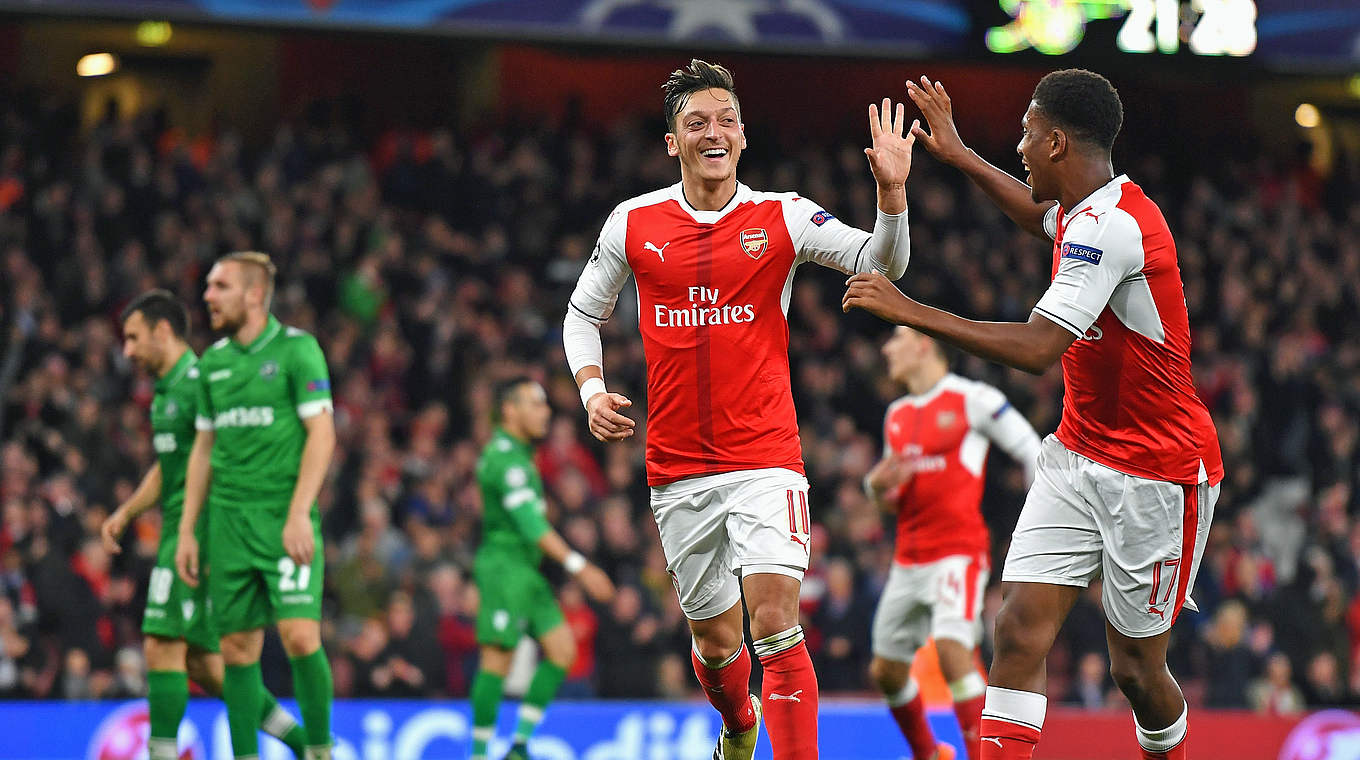 Three goals and an assist! Özil celebrates with teammate Iwobi © 2016 Getty Images