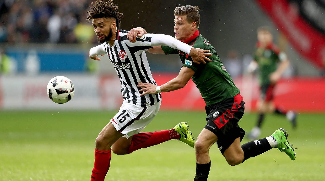 Frankfurt's Michael Hector (left) hold off Florian Niederlechner, who scored his side's two goals © 2017 Getty Images