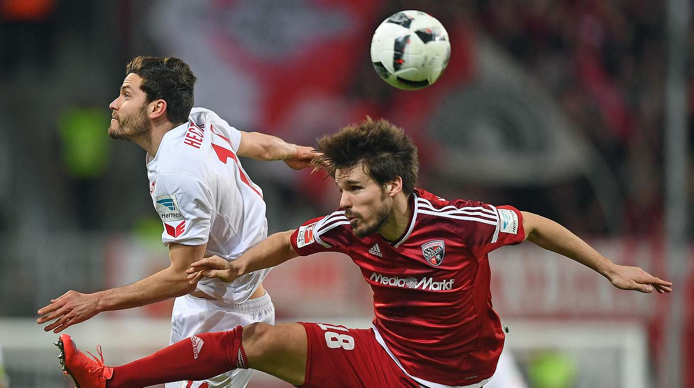 Germany international Jonas Hector contests a ball with Ingolstadt's Romian Bregerie © 2017 Getty Images