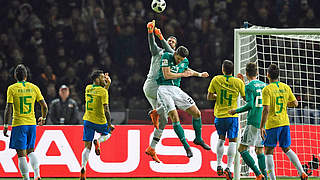 Mario Gomez is beaten to the ball by Brazil goalkeeper Alisson. © AFP/Getty Images