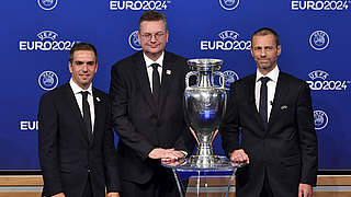 Philipp Lahm poses with DFB president Reinhard Grindel and UEFA president Aleksander Čeferin after Germany are awarded EURO 2024.  © UEFA