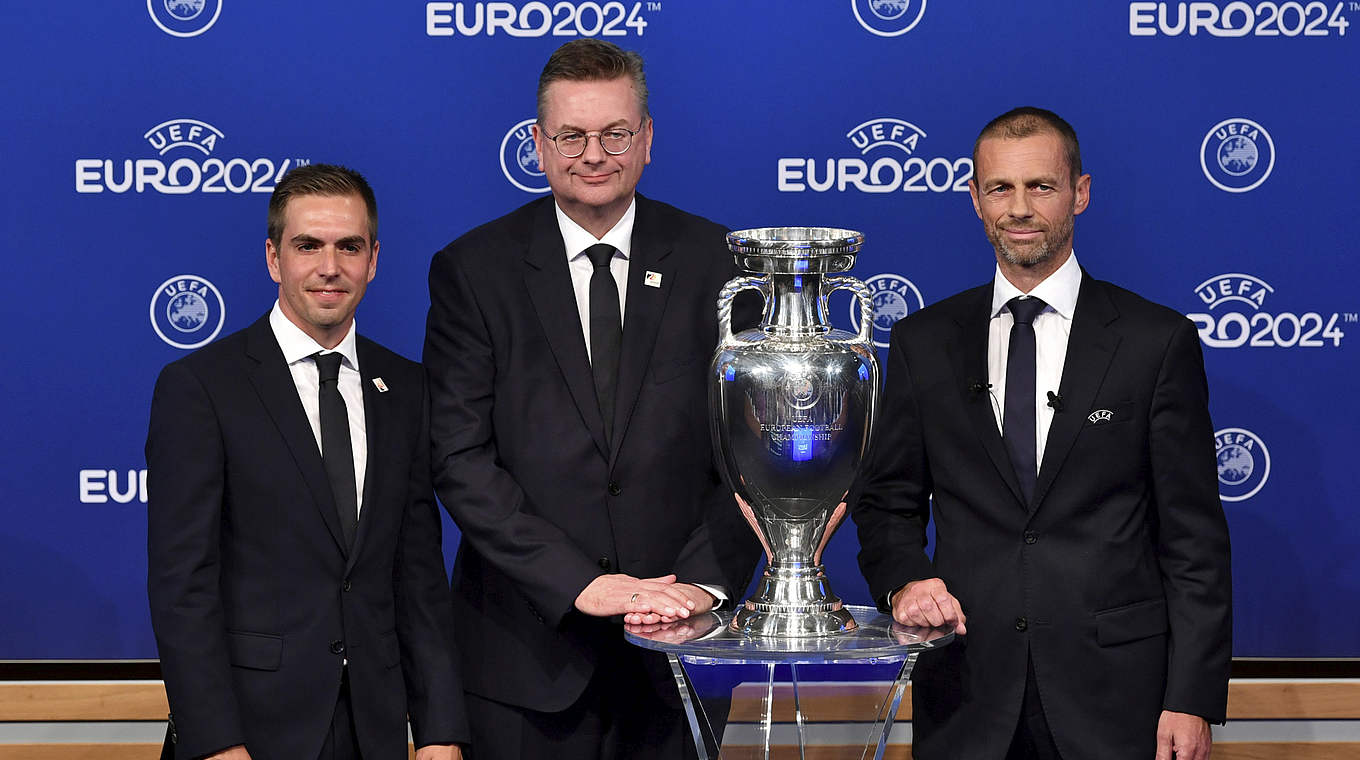 Philipp Lahm poses with DFB president Reinhard Grindel and UEFA president Aleksander Čeferin after Germany are awarded EURO 2024.  © UEFA