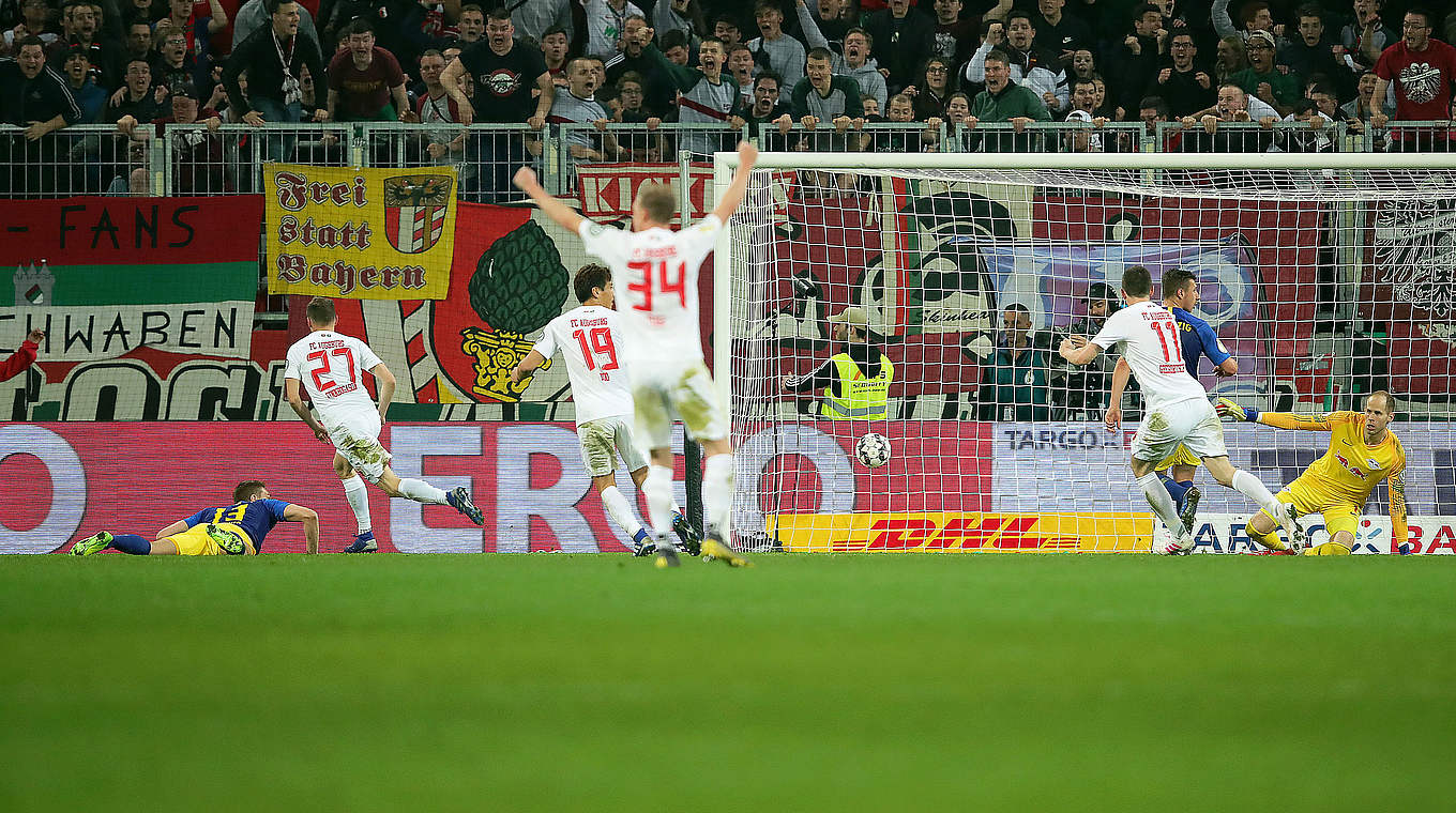 Augsburg celebrate injury time equaliser to take the game to extra time. © Getty Images