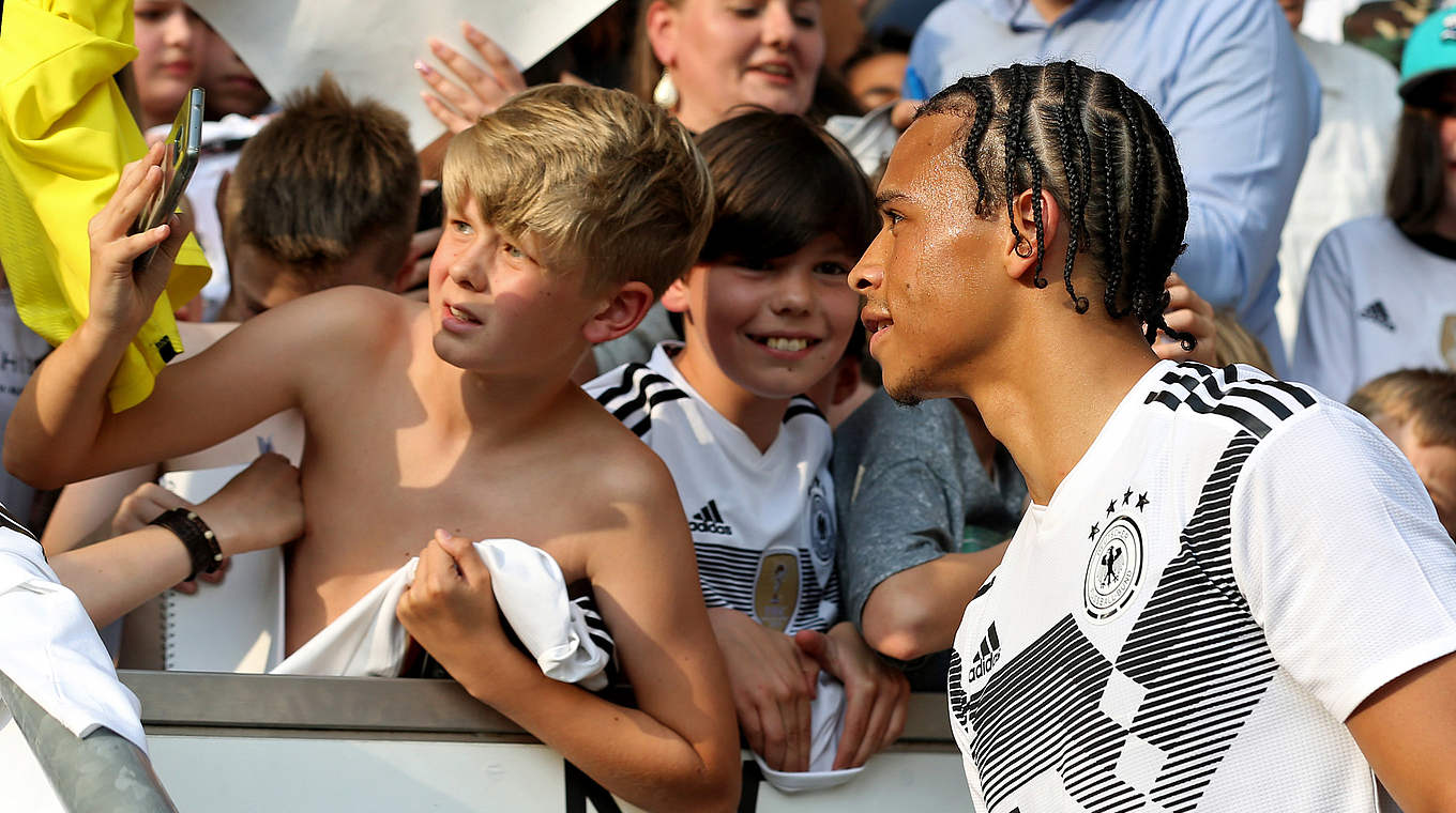 Man City Star Leroy Sané getting a photo with young fans. © 2019 Getty Images
