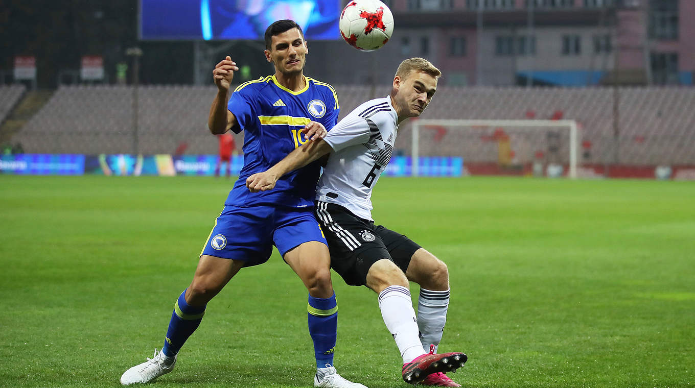 Challenging for the ball: Tim-Henry Handwerker outmuscles Bosnia's Petar Bojo © Getty Images