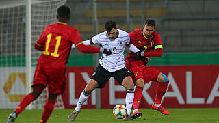 Janni Serra fends off two Belgium defenders. © 2019 Getty Images