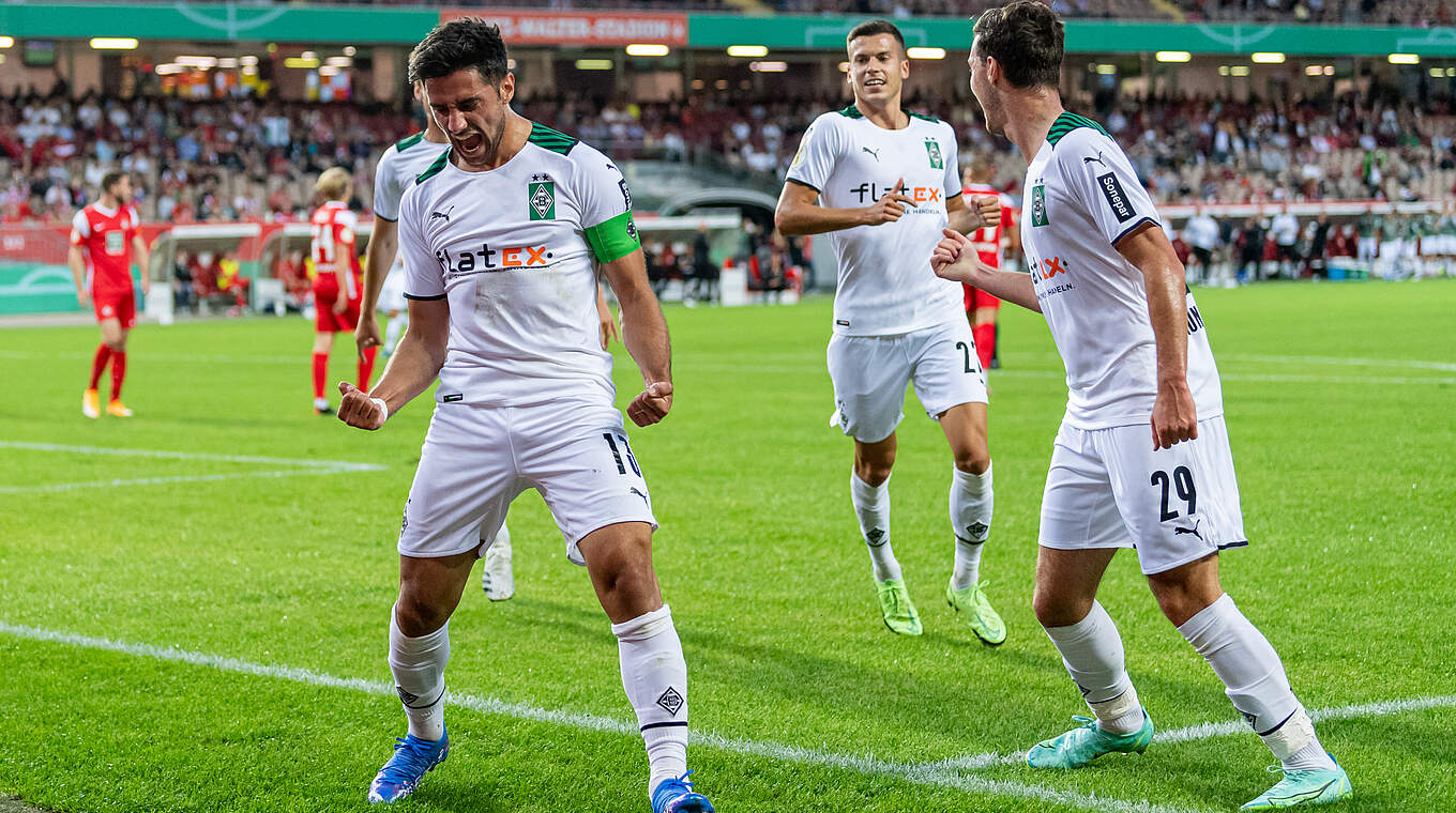 Gladbach's Lars Stindl (l.) celebrates after opening the scoring for his side.  © 