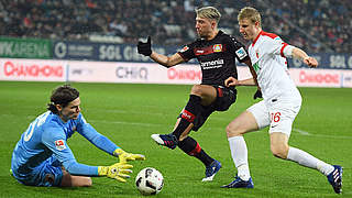 Germany international Julian Brandt and Augsburg captain Paul Verhaegh challenging for the ball © 2017 Getty Images