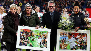 Neid and Sandrock present Angerer and Sasic with flowers and a collage of their careers © 2015 Getty Images